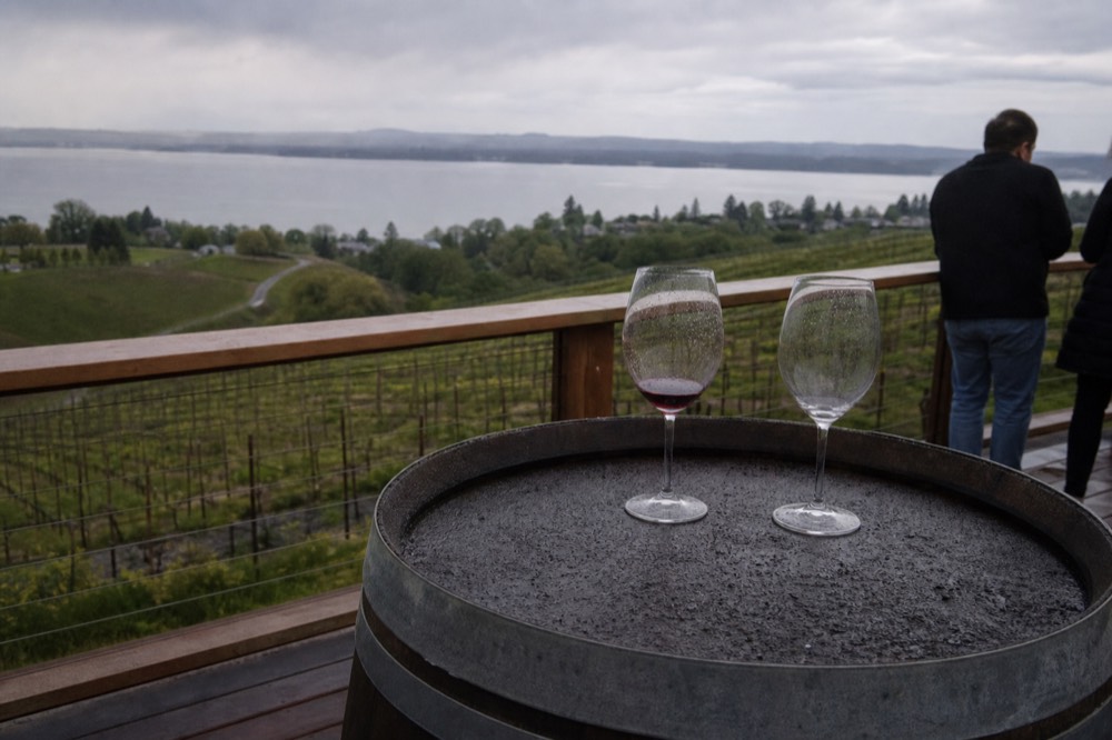 Wine glasses on a barrel overlooking Keuka Lake, no text, no logos, no people
