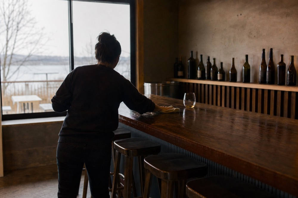 A tasting bar being wiped down at the end of the day, no text, no logos, no people