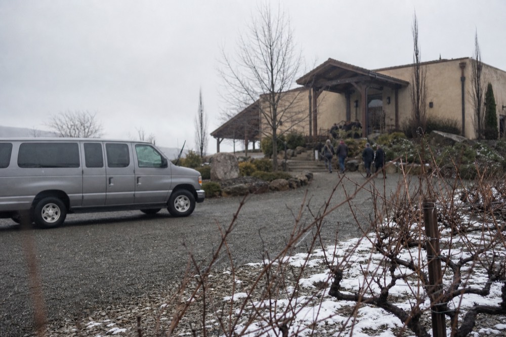 A passenger van parked outside a Finger Lakes winery entrance, no text, no logos, no people